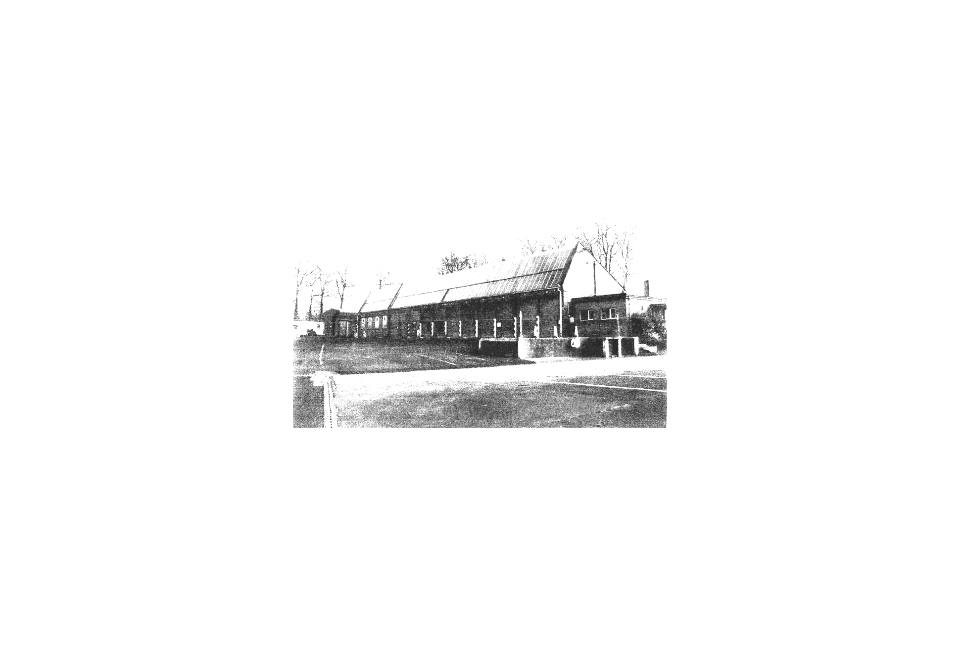 Old photograph of demolished barracks buildings 121-125. Unique gable profile and associated north light roof feature.