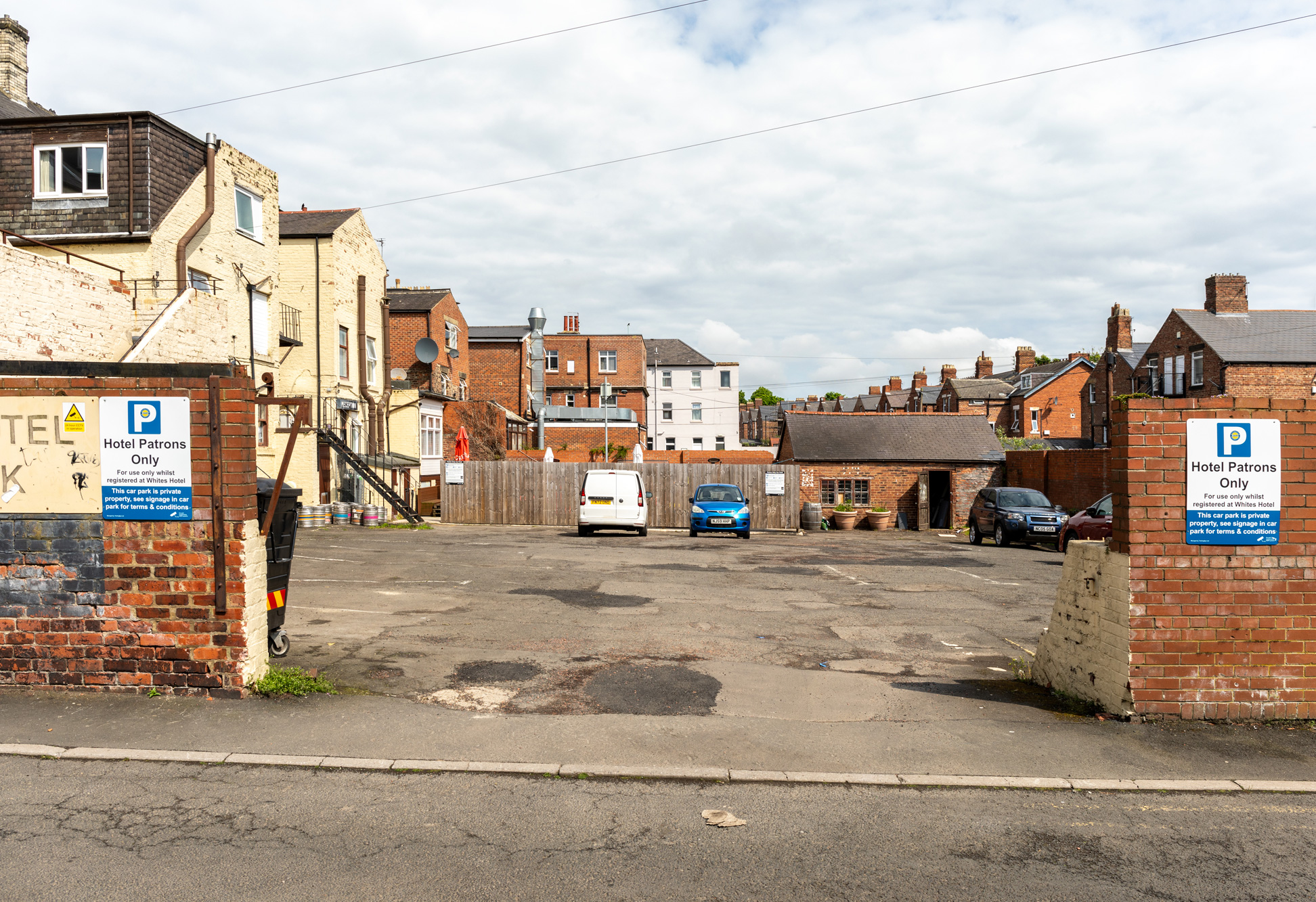Photograph of view into existing car park from Lily Avenue, vehicular access point.