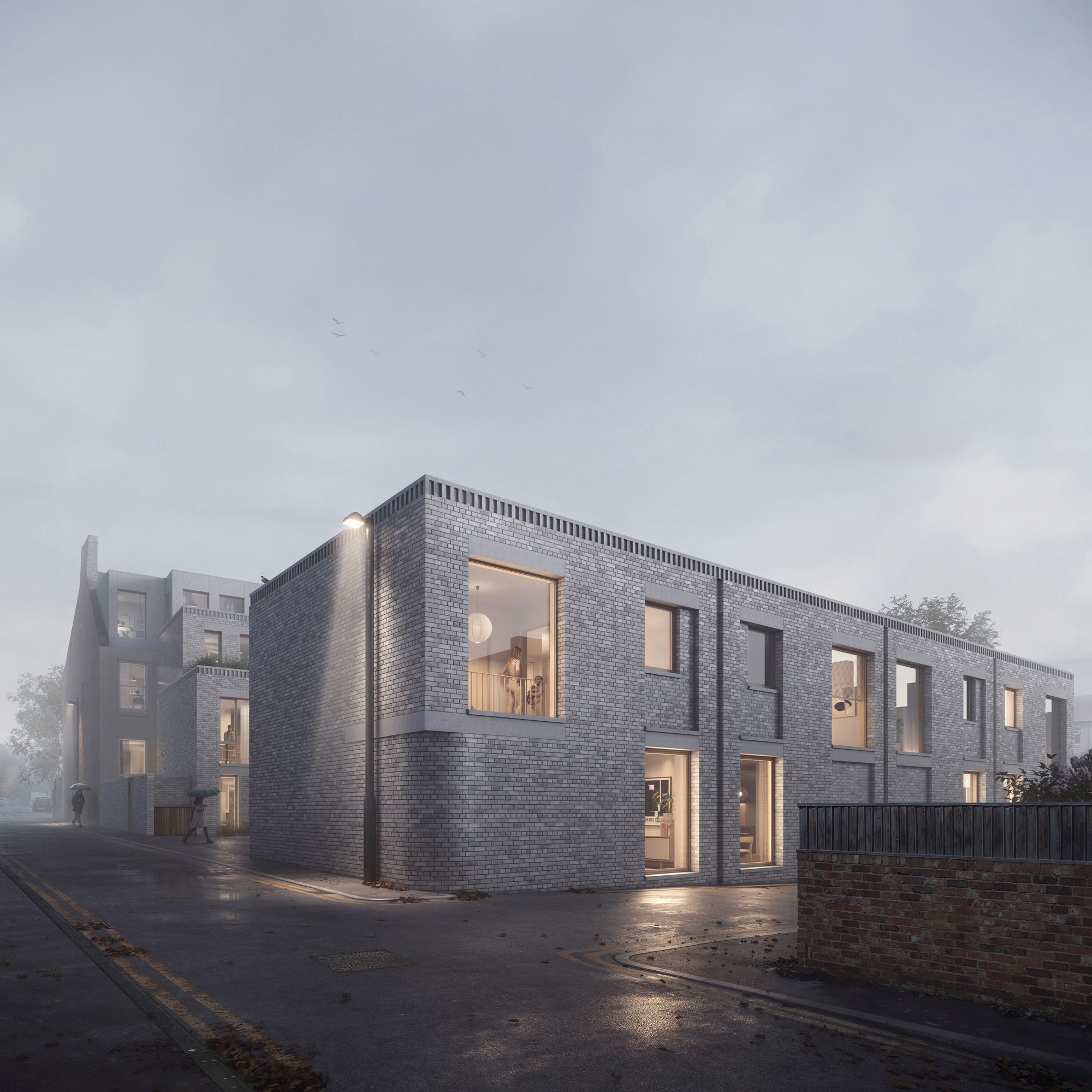 Artist’s impression of the proposed Moseley Passage development viewed from the junction with Lily Avenue, showing a two-storey mews terrace defining the street edge along Moseley Passage. The image illustrates the relationship between the new-build elements and neighbouring buildings, highlighting the stepped massing, prominent gable forms, pale brick façades, and the entrance leading to the internal courtyard.