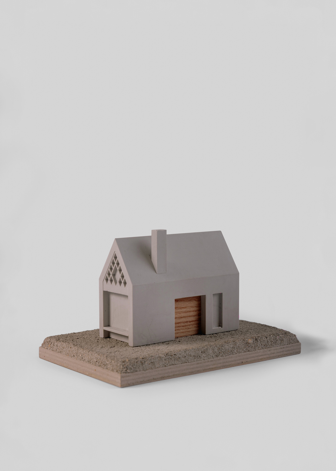 Photograph of a 1:100 Jesmonite physical model of the Glen Aray TRS proposal, with the retained former telephone repeater station subtly represented in oak and the proposed extensions cast in Jesmonite.